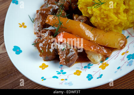 Seco de Chivo - Secos are thick Ecuadorian stews, usually served with yellow rice and fried plantains Stock Photo