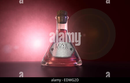 A regular old goblet glass bottle filled with a pink liquid with a label showing it is love potion and sealed with a cork on a s Stock Photo