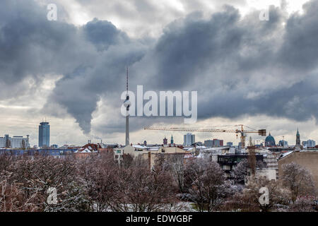 Berlin Skyline with snow covered trees, fernsehturm and dramatic cloudy sky, Mitte, Berlin, Europe Germany Stock Photo