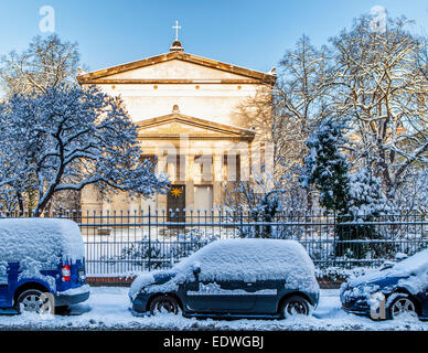 The Saint Elizabeth Evangelical church and snow covered cars and trees in Winter,  Invalidenstrasse, Mitte, Berlin, Germany Stock Photo