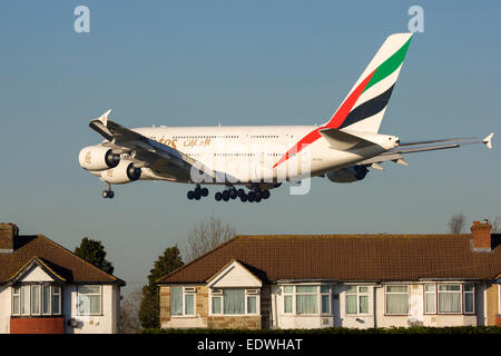 Emirates Airbus A380 lands over houses at London Heathrow Stock Photo