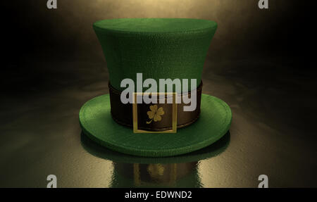 A green material leprechaun hat with a brown leather band emblazened with a gold shamrock and buckle on a dark spotlit backgroun Stock Photo