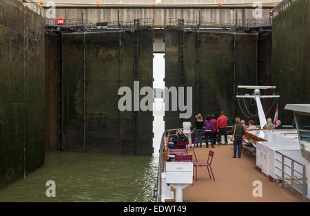 Cruise barge and freight boat in the large locks on River Danube near Altenworth, Austria Stock Photo