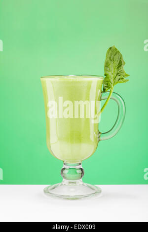 Green Smoothy in the glass on green background Stock Photo