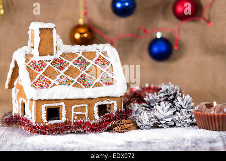 traditional gingerbread house on a background of Christmas decorations Stock Photo