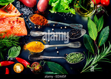 Delicious  portion of fresh salmon fillet  with aromatic herbs, spices and vegetables - healthy food, diet or cooking concept Stock Photo