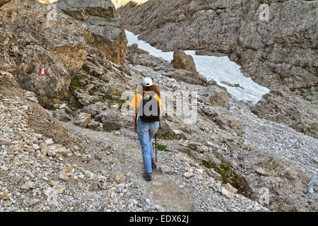 hiker walks on pathway in Val Setus, Alto Adige, Italy Stock Photo