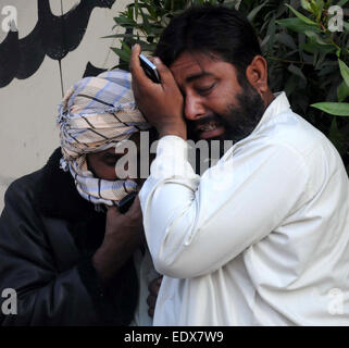 (150111) -- KARACHI, Jan. 11, 2015 (Xinhua) -- Pakistani mourners react outside a hospital in southern Pakistani port city of Karachi, Jan. 11, 2015. At least 59 people were killed and four others injured when a passenger bus hit an oil tanker in Pakistan's southern port city of Karachi on early Sunday morning, hospital sources said.  (Xinhua/Masroor) Stock Photo