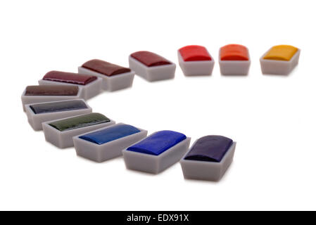 Artists watercolour pan paints arranged in an arc. A pallet of colour. Stock Photo