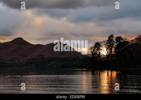 Dawn Sunrise over Cat Bells Fells reflected in Derwentwater lake, Keswick town, Lake District National Park, Cumbria, England,UK Stock Photo