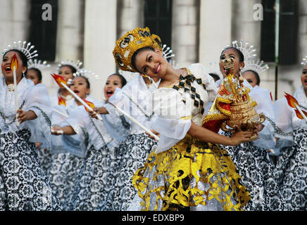 (150111) -- CEBU, Jan. 11, 2015 (Xinhua) -- Students wearing colorful costumes participate in street dancing during the Sinulog Festival in Cebu Province, the Philippines, Jan. 11, 2015. The annual Sinulog Festival showcases street dancers in bright colored costumes dancing gracefully to the rhythm of drums, trumpets and native gongs while carrying miniature statues of Santo Nino. (Xinhua/Stringer) (zjy) Stock Photo