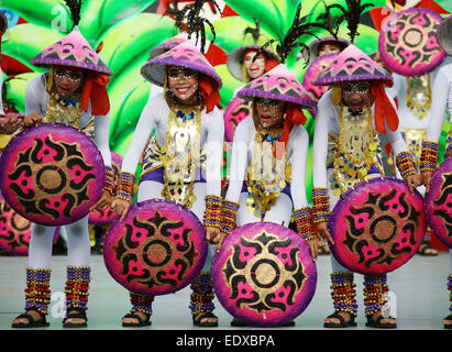 (150111) -- CEBU, Jan. 11, 2015 (Xinhua) -- Students wearing colorful costumes participate in street dancing during the Sinulog Festival in Cebu Province, the Philippines, Jan. 11, 2015. The annual Sinulog Festival showcases street dancers in bright colored costumes dancing gracefully to the rhythm of drums, trumpets and native gongs while carrying miniature statues of Santo Nino. (Xinhua/Stringer) (zjy) Stock Photo