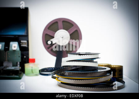 Vintage 8mm movie editing desktop with reels and elements in out of focus background, color effect Stock Photo