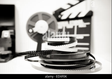 A vintage 8mm movie editing desktop in black and white with 8mm reels and elements in out of focus background Stock Photo