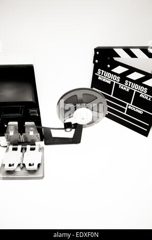A vintage 8mm movie editing desktop in black and white with editing machine, reel and clapper Stock Photo
