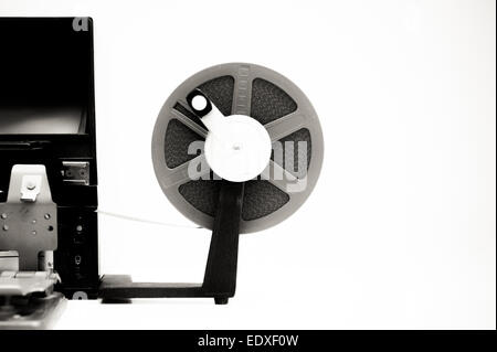 A vintage 8mm movie editing desktop in black and white with editing machine and reel on white background Stock Photo