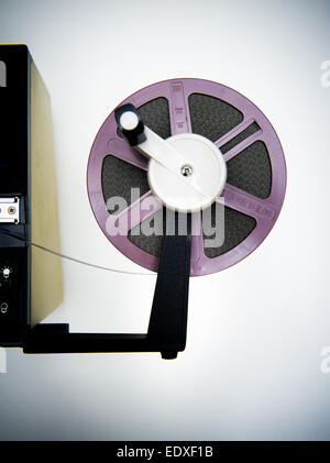 A vintage 8mm movie editing desktop with editing machine body part and purple reel, vintage color effect Stock Photo