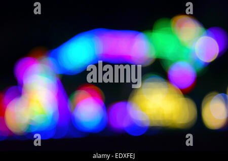 Flashing multicolored lights that were blurred by zooming the camera lens during exposure produced this unusual abstract image and arresting background.