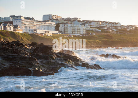 Crashing waves at Fistral beach with view to buildings on Pentire Head, Newquay, Cornwall. Stock Photo