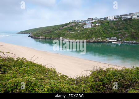 The river Gannel meeting the sea at Crantock beach, Newquay, Cornwall. Houses on the clifftops overlooking the river. Stock Photo