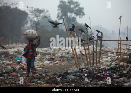 Dhaka, Bangladesh. 11th Jan, 2015. A slum child collect rubbish for resale from a dump yard near rail line in Dhaka. At the end of the day, they earn TK 50 to 70 USD 1 The Matuail dump yard is one of the three waste sites of Dhaka. Credit:  zakir hossain chowdhury zakir/Alamy Live News Stock Photo