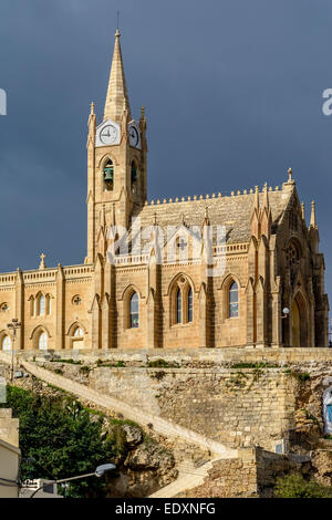 Lourdes Church, a neo-gothic monument built in 1888 on the coastal village of Mgarr on the island of Gozo, Malta Stock Photo