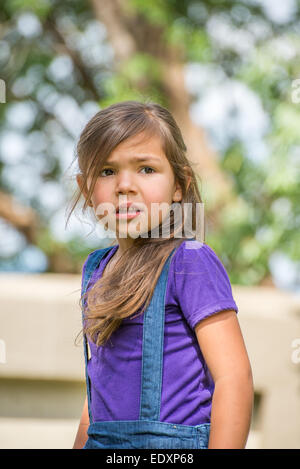 Little girl looking in to the distance with a concerned look on her face. Stock Photo