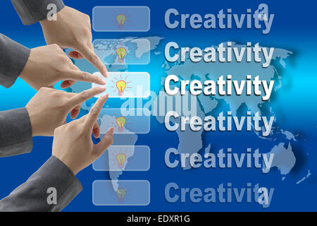 male business hand pushing on Creativity button with world map background Stock Photo