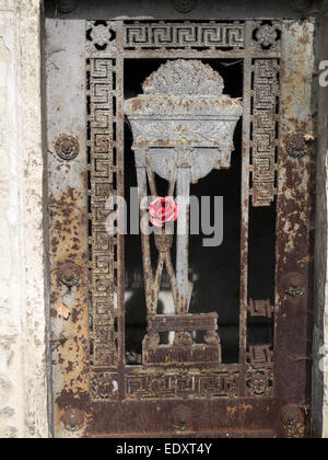 An artificial rose decorates a mausoleum in a cemetery in Paris, France Stock Photo