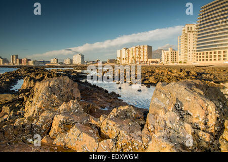 The reef at low tide in front of the town called Strand in the Western Cape, South Africa Stock Photo