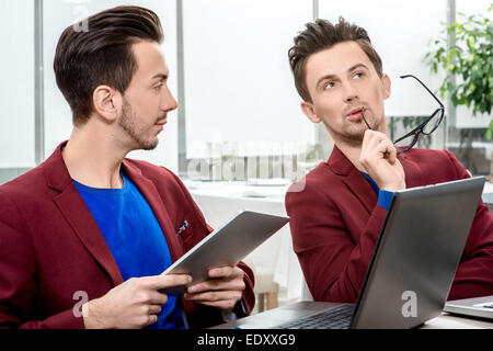 Two brothers twins working at the office Stock Photo