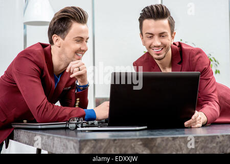 Two brothers twins working at the office Stock Photo