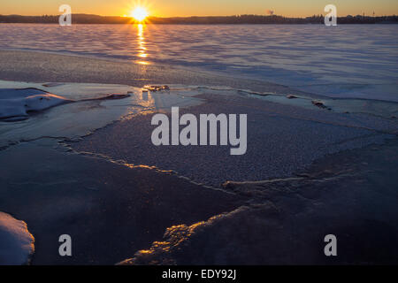 Sunrise over frozen and snowy lake in the winter in Tampere, Finland Stock Photo