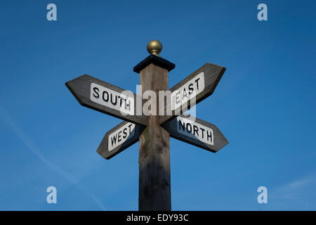 Signpost showing directions to the north, south east and west. Stock Photo