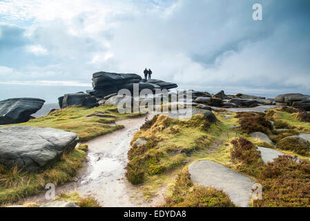 Hikers in Peak District during Autumn sunset. Stock Photo