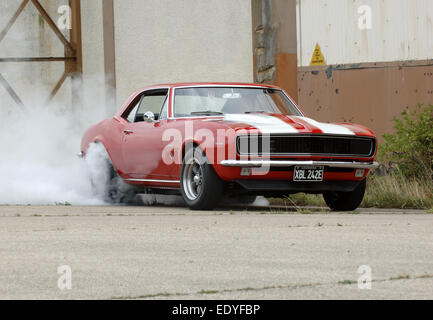 1967 Chevrolet Camaro American muscle car doing a tyre smoking burnout Stock Photo