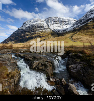 The river Coe with the cliffs of the Aonach Dubh buttress in the background Stock Photo