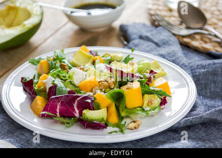 Avocado with Mango,Rocket ,Walnut and Feta salad by Balsamic dressing Stock Photo