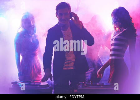 Group of girlfriends dancing in nightclub while dj playing cool music Stock Photo