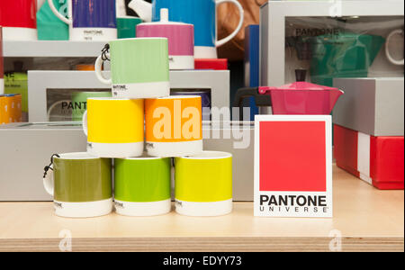 Olympia, London, UK. 12th January, 2015. Top Drawer, Home and Craft gift and fashion accessories trade show runs from 11-13 January where retail buyers can meet innovative exhibitors and designers. Whitbread Wilkinson stand with Pantone Universe coffee cups. Credit:  Malcolm Park editorial/Alamy Live News Stock Photo