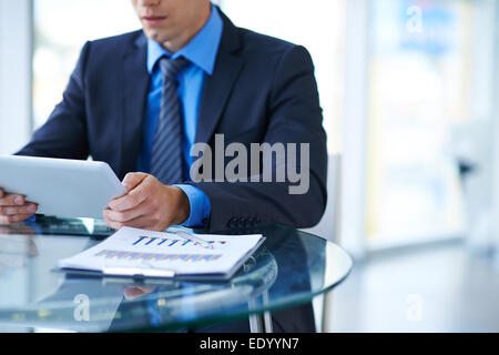 Young businessman using digital tablet at workplace Stock Photo