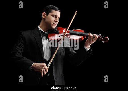 Studio shot of a classical violinist playing a violin on black background Stock Photo
