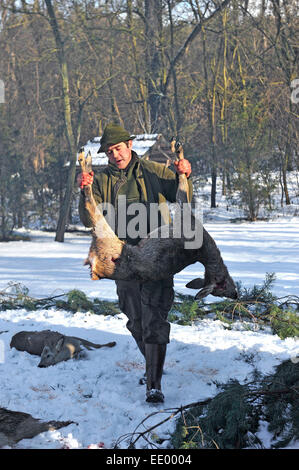 hunter carrying dead deer Stock Photo
