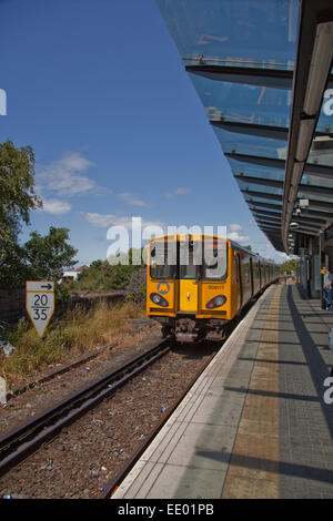 The next train to Liverpool,pulls into Maghull station on a bright summers' day,on the commuter line into Liverpool. Stock Photo