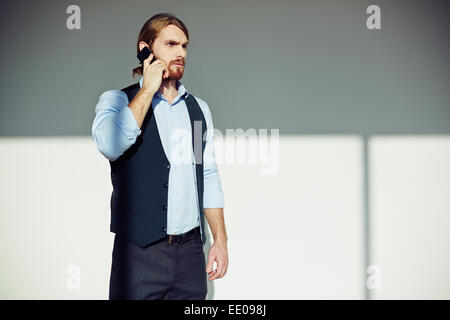 Serious man talking on the phone Stock Photo