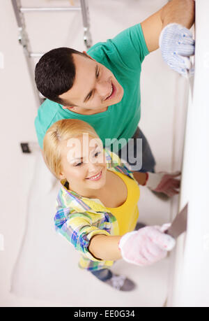 smiling couple doing renovations at home Stock Photo