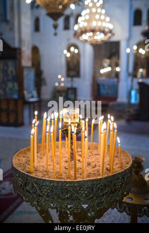 Candles burning in a Greek Orthodox Church in the village of Exohori, Outer Man, Peloponnese, Greece. Stock Photo