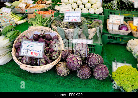 Munich, Bavaria, Germany. Artichokes and other vegetables on sale in the Viktualienmarkt Stock Photo