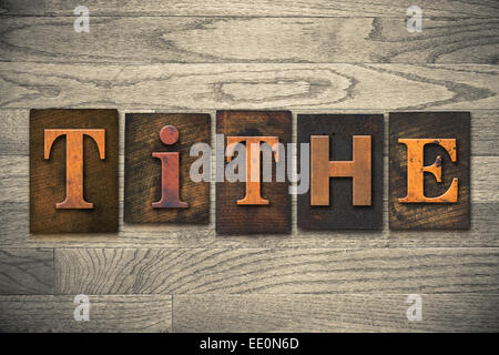 The word "TITHE" written in wooden letterpress type. Stock Photo