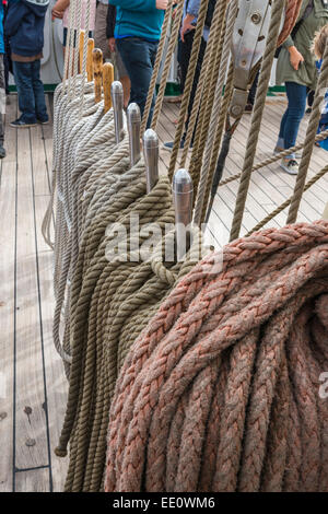 Ropes and belaying pins on the deck of a Tall Ship sailing vessel - EDITORIAL USE ONLY Stock Photo